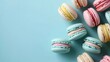 Colourful macarons sweet dessert on pastel background with free place for text. French cuisine, macaroon bakery concept