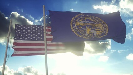 Wall Mural - The Nebraska state flags waving along with the national flag of the United States of America. In the background there is a clear sky