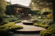 Luxurious landscaping in the home garden with various flowers, plants, shrubs, trees and a wooden path. The front yard of the house, Landscape, landscaping in spring and summer.
