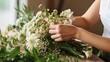 Hands of a florist arranging a corsage