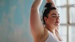 © Anna Zhuk - Close-up beautiful plus size model on yoga practice in a bright room, pastel blue background