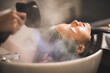 © chokniti - client woman clean washing a hair in salon, professional hairdresser washing haircut customer hair with water and shampoo treatment, coiffure beauty head hair care, fashion service