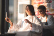 © chokniti - Asian Hairdresser giving treatment and barber occupation service, Professional hairstylist combing and using scissors cut woman's hair to young beautiful customer girl in beauty salon