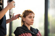 © chokniti - Asian Hairdresser giving treatment and barber occupation service, Professional hairstylist combing and using scissors cut woman's hair to young beautiful customer girl in beauty salon