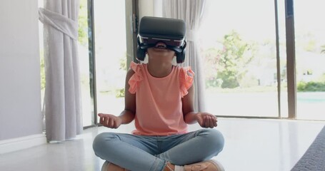 Wall Mural - happy biracial girl wearing vr headset using virtual interface at home, slow motion