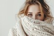 Cozy portrait of a woman in a warm sweater, white background