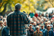 Farmer spokesperson addressing the crowd, a scene featuring a farmer spokesperson addressing a large crowd during a protest.