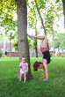 © Dasha Petrenko - Young woman exercising with her baby in park