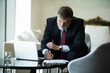 © opolja - Mature busy elegant bearded company director, checking the company finances, at the modern office