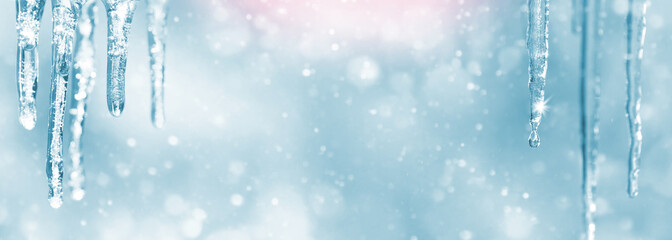 Wall Mural - Background of bright transparent icicles in the sunlight. Spring background with icicles. Beautiful background for greeting cards