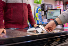 Man Using Bank Card Through NFC Or WIFI Or Touch Less To Pay In Bookshop Or Gifts Shop