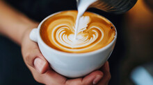 Close-up Of A Man Making Latte Art In A Cup Of Coffee. Male Hands Holding A Cup Of Coffee With Latte Art. Drinks Concept.