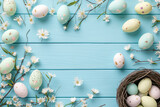 Fototapeta  - Speckled Easter eggs scattered on a blue wooden surface with white flowers and a nest full of eggs.