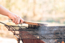 Preparing Barbecue Grill With Wire Brush Cleaning