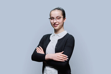 Wall Mural - Portrait of confident smiling teenager girl on grey background