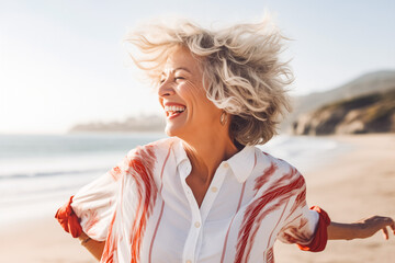 happy dancing mature woman at the beach