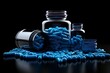 Pharmaceutical blue Pills with bottle, medicine concept on black