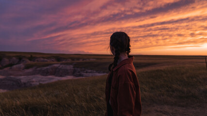 woman looking out at badlands sunset