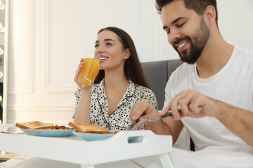 Sticker - Happy couple having breakfast on bed at home