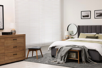 Wall Mural - Window with horizontal blinds and comfortable bed in room