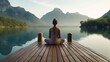 Woman meditating while practicing yoga near lake in summer, sitting on wooden pierRear 