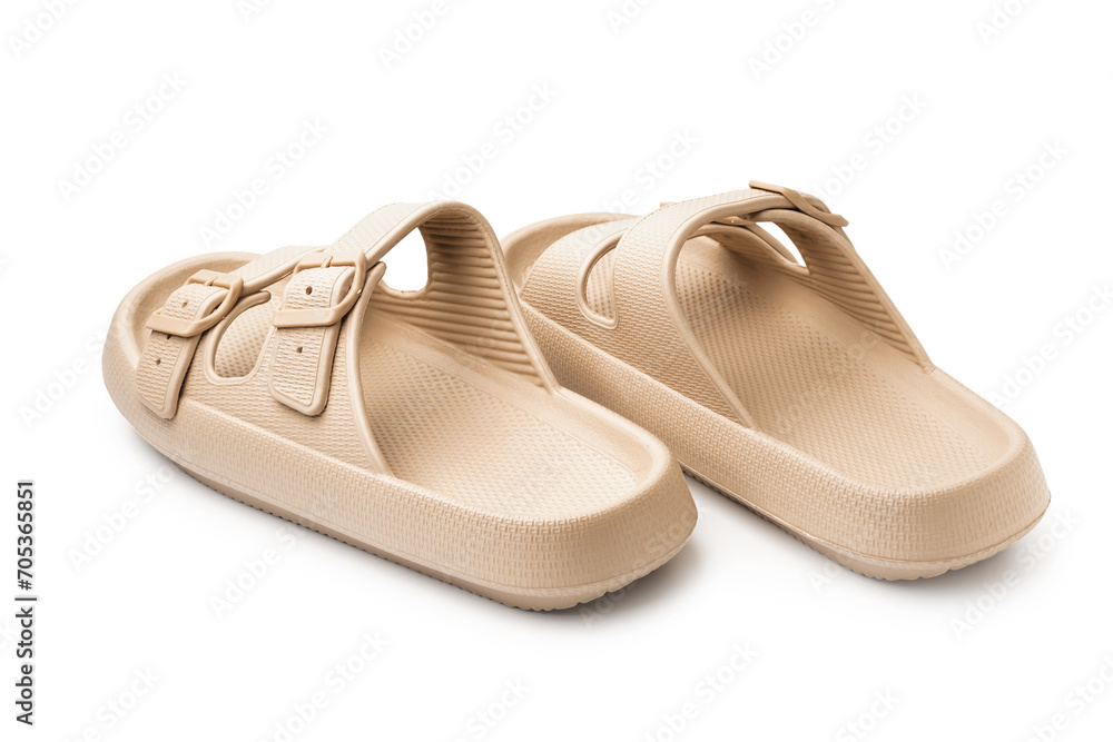Pair of stylish beige flip-flops on white background