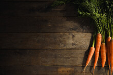 Fresh Carrots With Leaves On Wooden Background