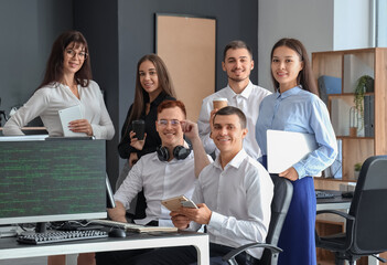 Team of young programmers working in office