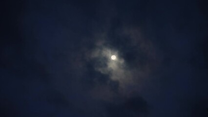 Wall Mural - under the soft glow of moonlight, night unfolds in dance of shadow and cloud