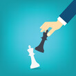 © madedee - Hand holding black chess king and knocking down white one, checkmate. Business Strategy concept.