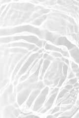Wall Mural - White water with ripples on the surface. Defocus blurred transparent white colored clear calm water surface texture with splashes and bubbles. Water waves with shining pattern texture background.