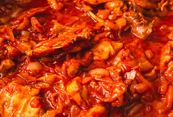 Sticker - Chicken meat is stewed in tomato in a frying pan