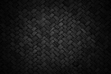 Old black bamboo weave texture background, pattern of woven rattan mat in vintage style.