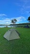 Hiking and setting up a tent near the river Vertical image format