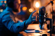 © Uliana - A podcaster passionately gesturing and making a point during a recording, with a blurred background and ample copy space.