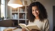 smiling teenage girl holding book at home 