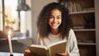 Portrait of a smiling teenage girl holding book at home