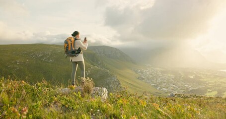 Wall Mural - woman, hiking and video recording on mountains in adventure, wellness and health with nature and cit