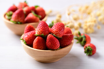 Wall Mural - Fresh strawberry fruit in wooden bowl on white background