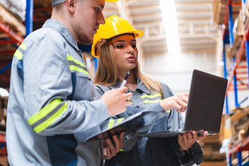 Wall Mural - Female engineer using laptop computer for safety control checks or manufacturing maintenance work in factory building or construction site. woman engineer inspector working in industry product line