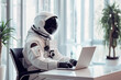 Astronaut working on a laptop in office
