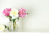 Fototapeta Tulipany - Bouquet of beautiful peonies in vase on white table. Space for text