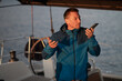 © zinkevych - Man on the yacht with a phone in hands