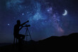 © New Africa - Astronomer with telescope pointing at starry sky outdoors