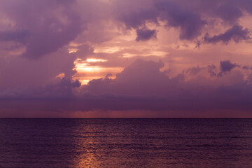 Wall Mural - colorful tropical sky. landscape photo with dark sunset clouds over the ocean