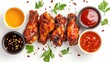 © buraratn - Air fryer chicken wings glazed with hot chilli sauce and served with different sauces. isolated on white background . top view