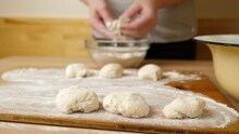 A Woman Forms Pieces Of Dough For Making Donuts. The Process Of Making Donuts