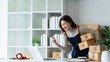 Young business woman entrepreneur online shipment business happy after preparing packages to send to customer success. online selling, e-commerce concept