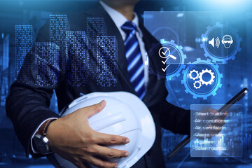 Engineer holding safety helmet and tablet to building inspection with technology on smart building and iot application construction before delivery to owner