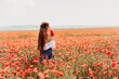 © svetograph - Woman poppies field. Side view of a happy woman with long hair in a poppy field and enjoying the beauty of nature in a warm summer day.